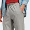 imageadidas Mens Essentials Logo Tapered Badge SweatpantsMedium Grey Heather