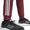 imageadidas Mens Essentials Fleece Tapered Cuff 3Stripes PantsShadow Red