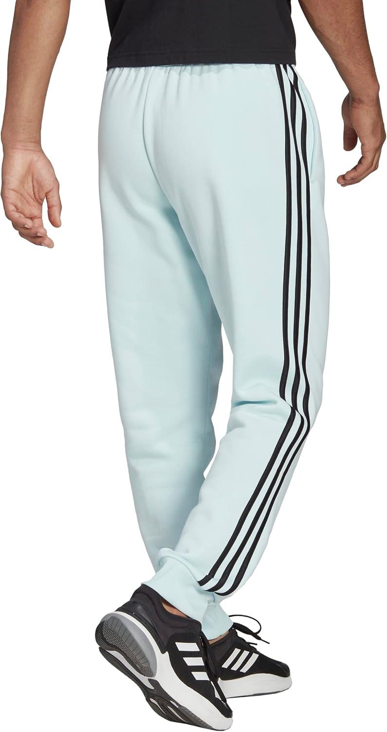 imageadidas Mens Essentials 3Stripes Fleece Tapered Cuff PantsAlmost BlueBlack