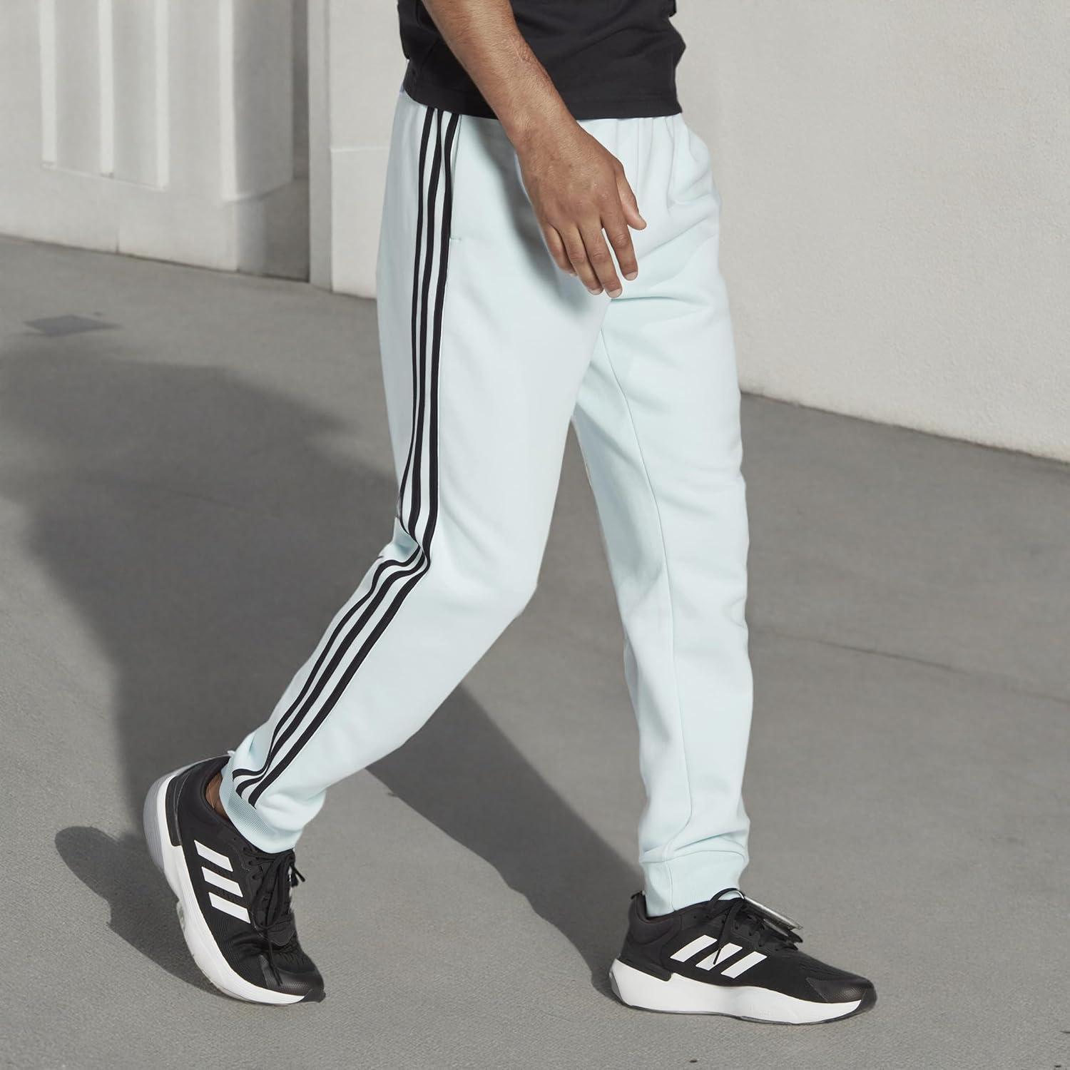 imageadidas Mens Essentials 3Stripes Fleece Tapered Cuff PantsAlmost BlueBlack