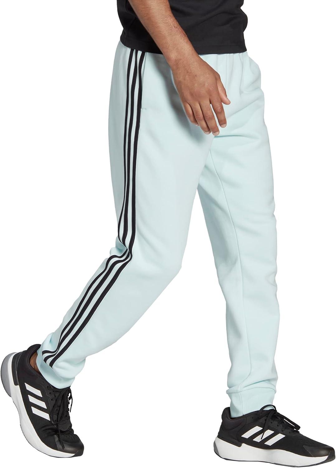 imageadidas Mens Essentials 3Stripes Fleece Tapered Cuff PantsAlmost BlueBlack