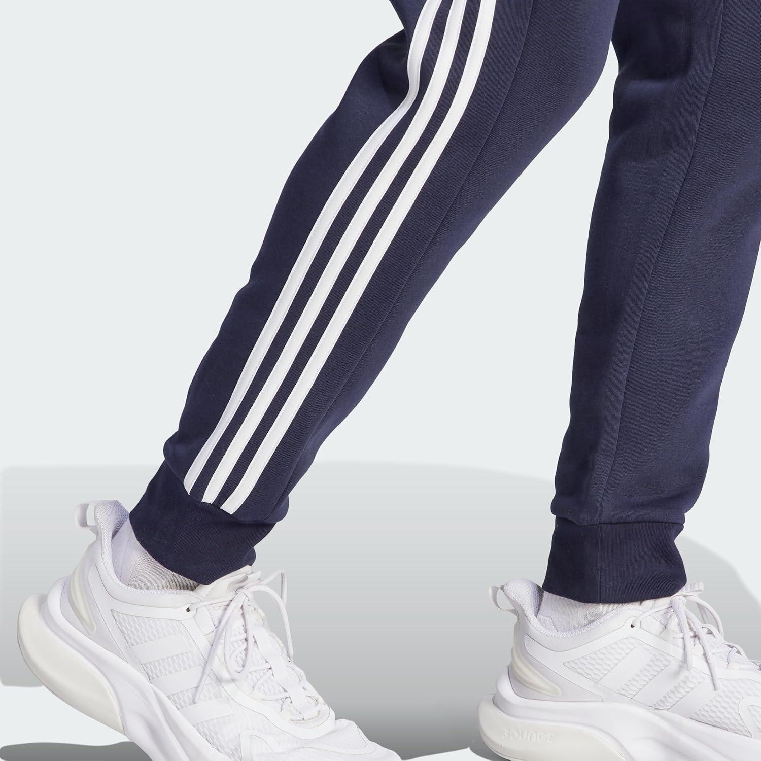 imageadidas Mens Essentials 3Stripes Fleece Tapered Cuff PantsInk