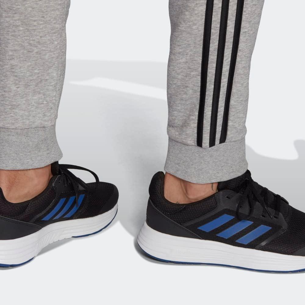 imageadidas Mens Essentials 3Stripes Fleece Tapered Cuff PantsMedium Grey HeatherBlack
