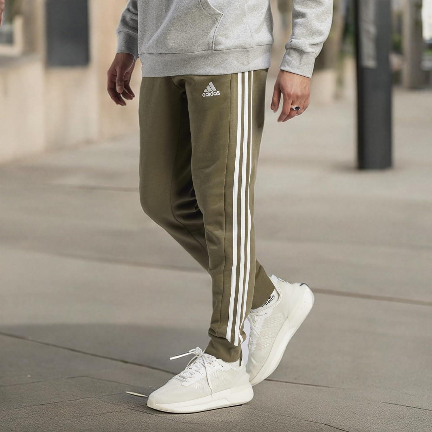 imageadidas Mens Essentials 3Stripes Fleece Tapered Cuff PantsOlive Strata
