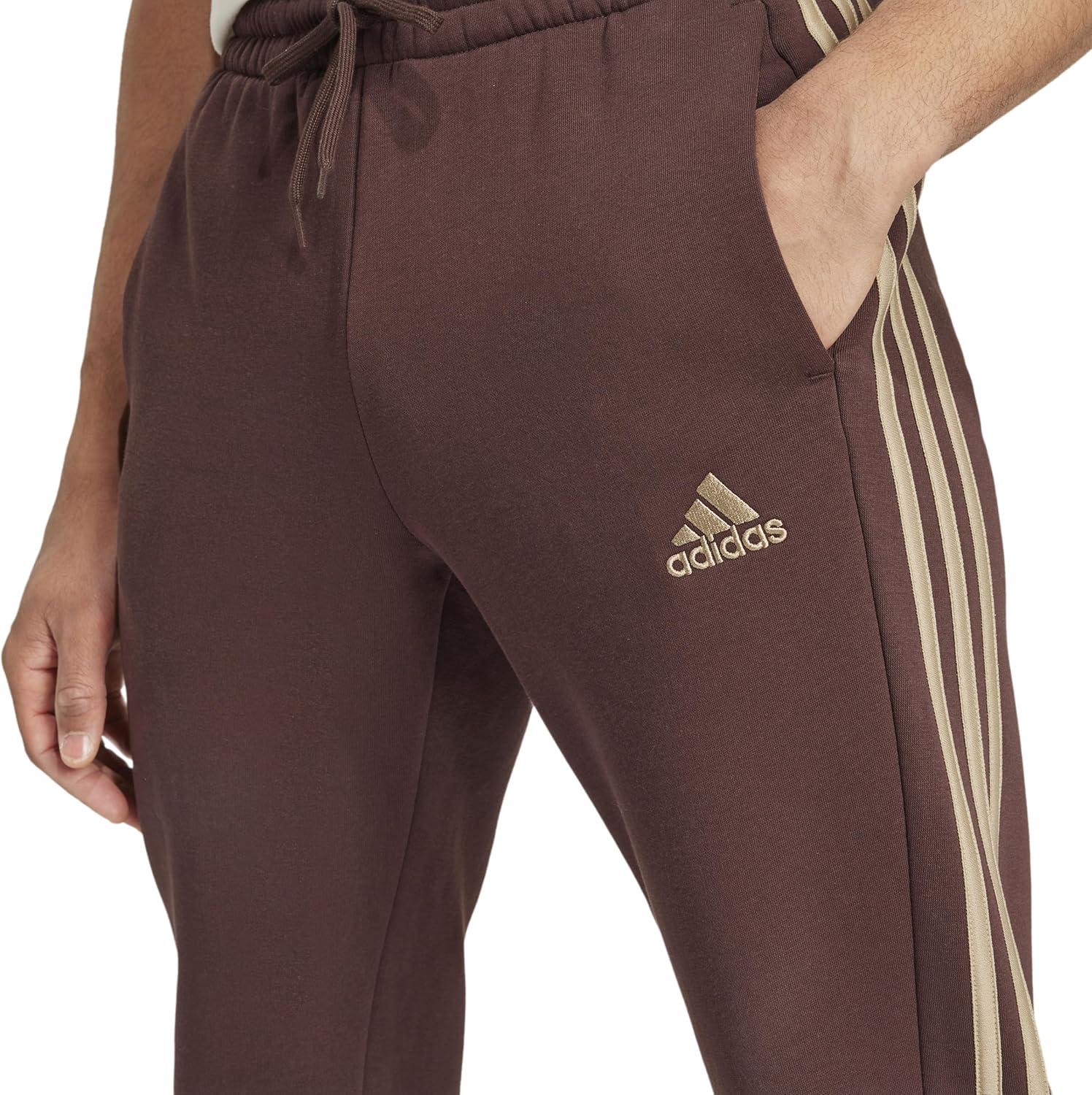 imageadidas Mens Essentials 3Stripes Fleece Tapered Cuff PantsShadow Brown
